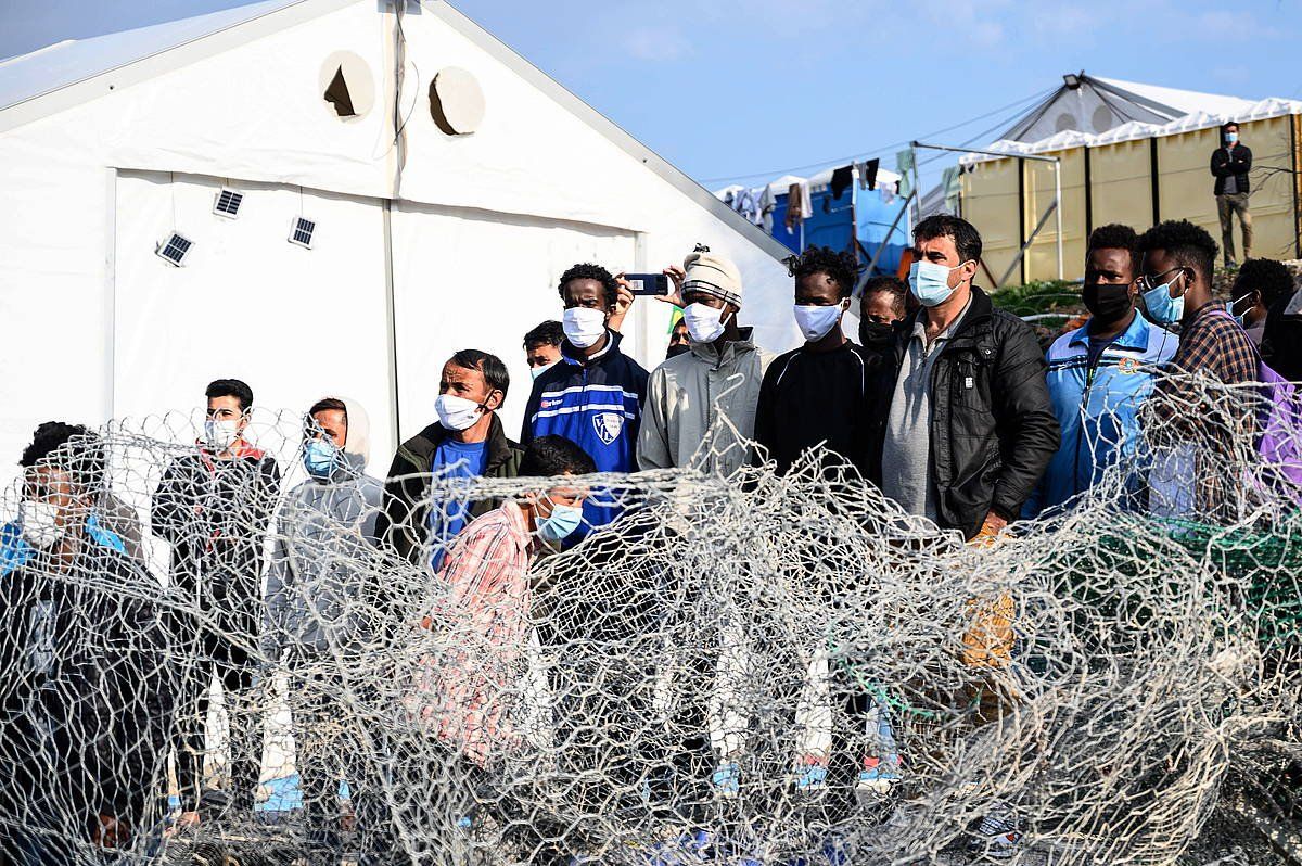 Hainbat migratzaile, Karatpe errefuxiatu kanpalekuan, iazko martxoan, Lesbosen (Grezia). VANGELIS PAPANTONIS / EFE