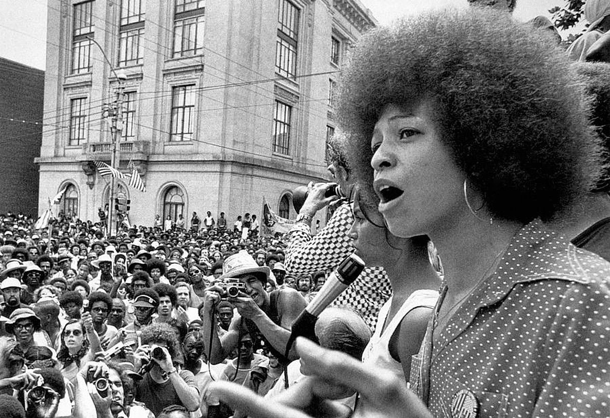 Angela Davis, gaztaroan, hitzaldi bat ematen beltz komunitatearen aurrean. Angela Davis, gaztaroan, hitzaldi bat ematen beltz komunitatearen aurrean.