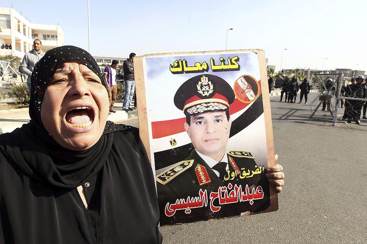 Emakume bat, Al-Sisiren argazki batekin, Kairoko Polizia Akademiaren atarian. KHALED ELFIQI / EFE.