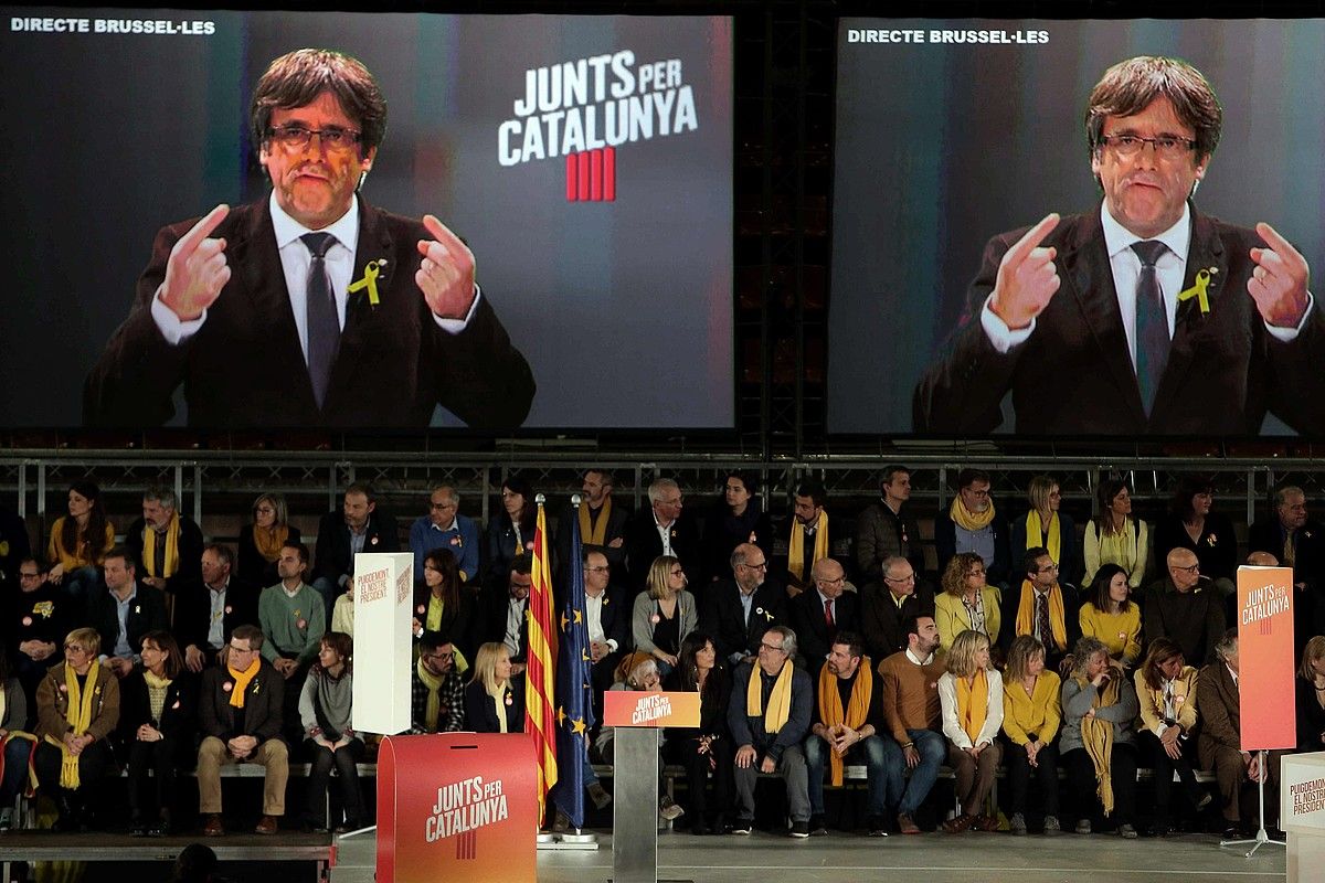 Carles Puigdemont bideo konferentziaz hitz egiten, Junts Per Catalunyak atzo egindako ekitaldian. TONI ALBIR / EFE.