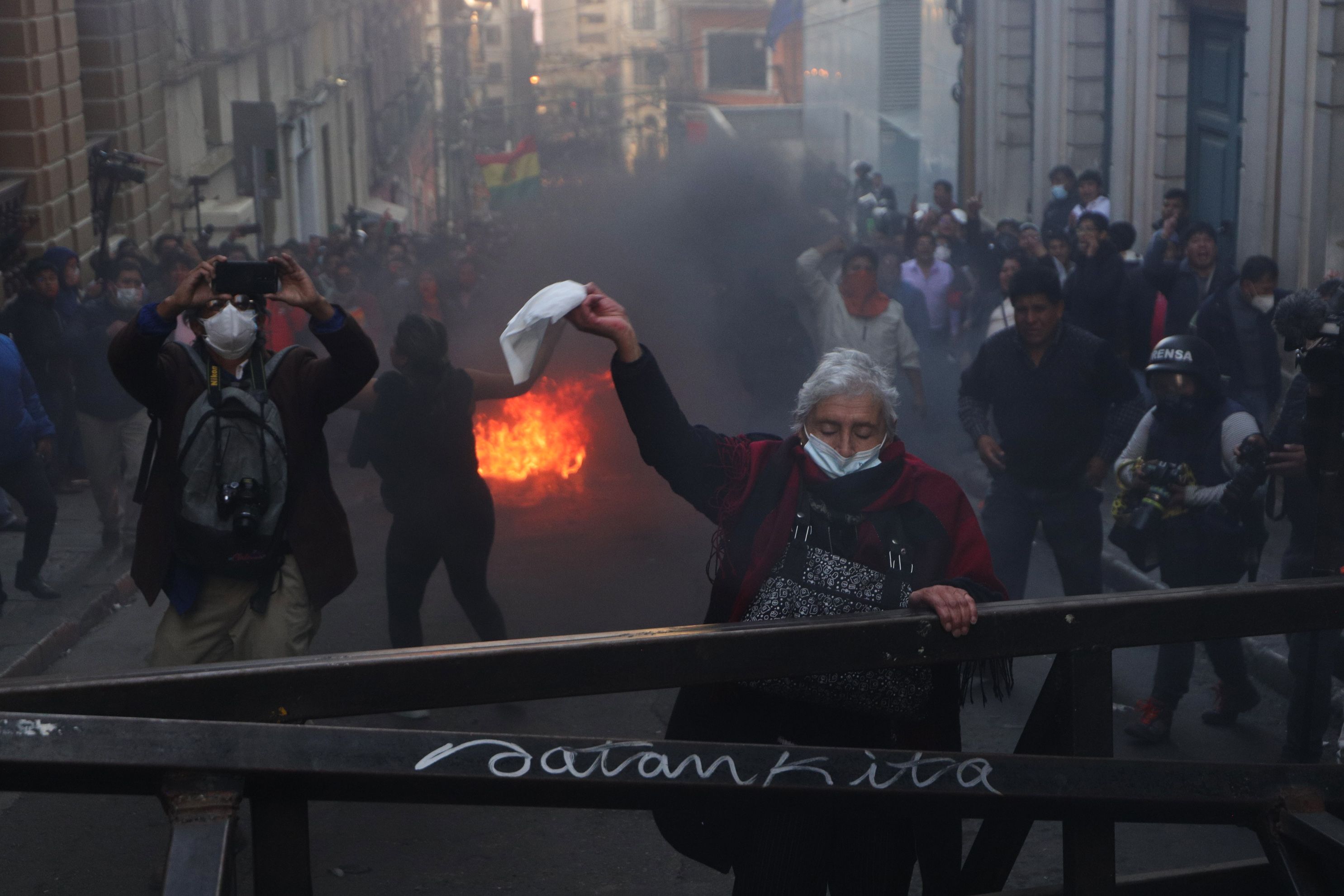Luis Arce presidentearen aldeko emakume bat, zapi zuri bat astintzen, militarren aurka protesta egiteko.