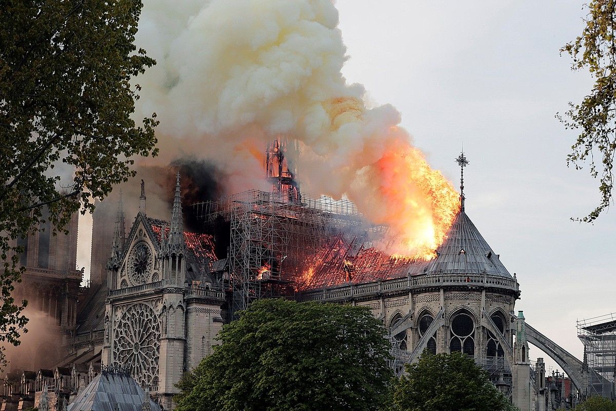Notre Dame katedralaren sabaia sutan, atzo arratsaldean, Parisko erdigunean. Katedralaren gezia eta sabaia erori ziren. IAN LANGSDON / EFE.
