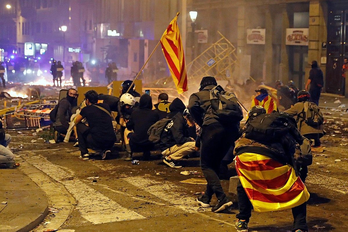 Manifestariak Poliziatik babesten, atzo iluntzean, Bartzelonan. TONI ALBIR / EFE. Manifestariak Poliziatik babesten, atzo iluntzean, Bartzelonan. TONI ALBIR / EFE.