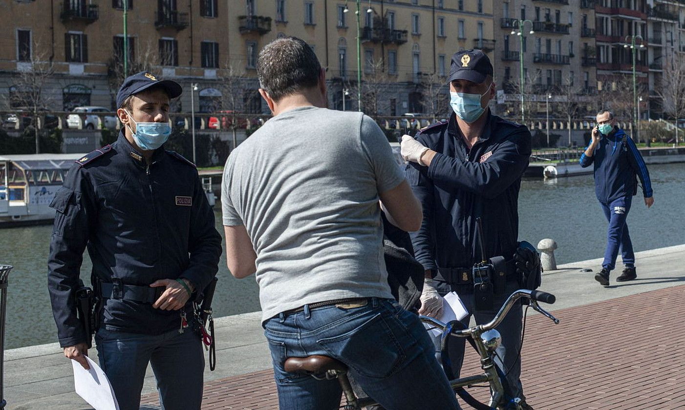 Polizia itxialdiari entzungor egin eta kalean dabiltzan herritarrak geldiarazten, Milanen. MARCO OTTICO / EFE.