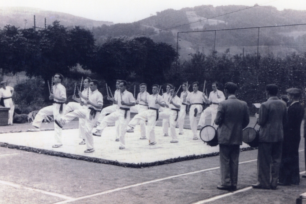 Joxe Lorentzo Pujana dantza maisuaren arauei jarraituz dantzari talde bat Ordizian dantzan, 1940eko hamarkadaren aurretik. Joxe Lorentzo Pujana dantza maisuaren arauei jarraituz dantzari talde bat Ordizian dantzan, 1940eko hamarkadaren aurretik.