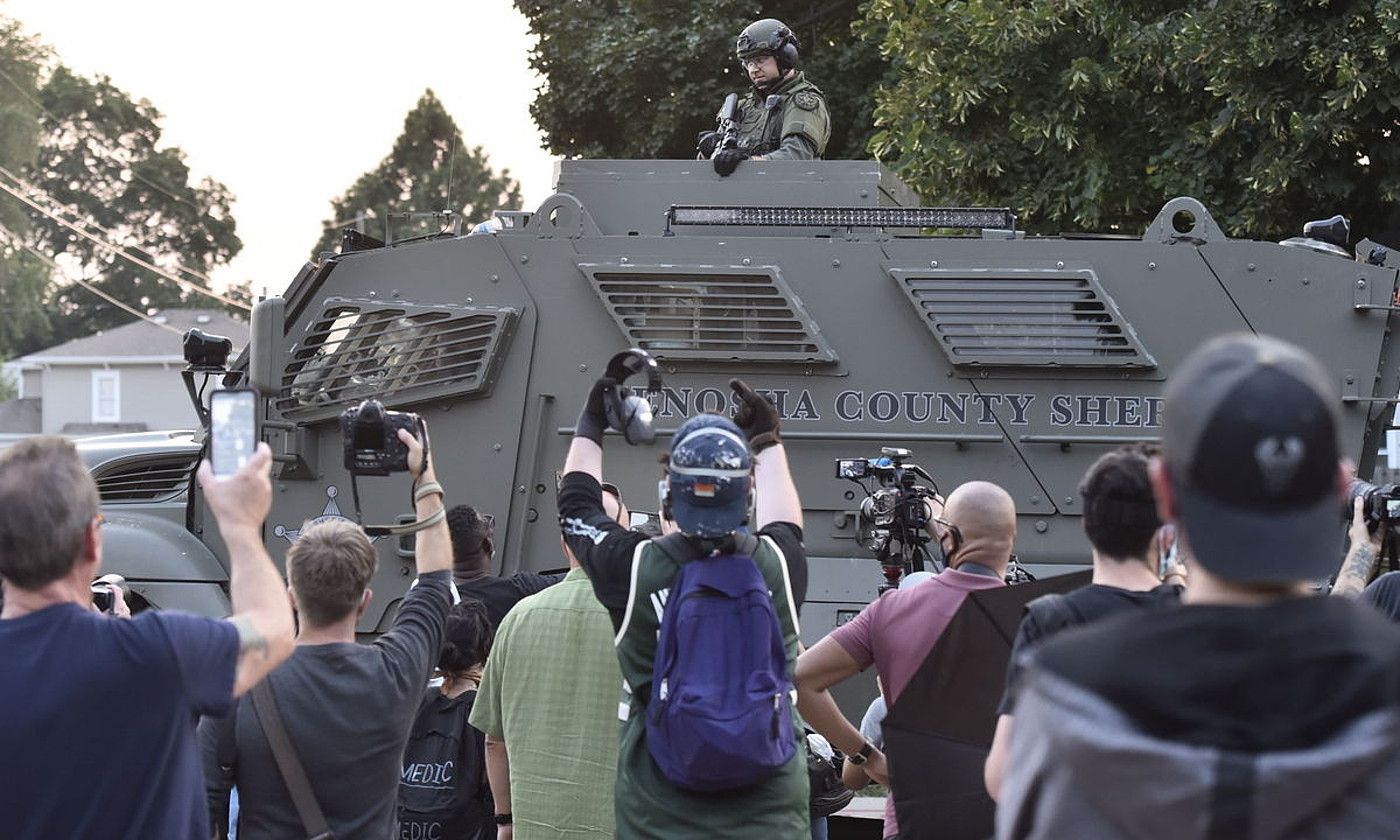AEBetako Poliziaren indarkeriaren aurkako protestariak agente armatu baten aurrean, herenegun. MATT MARTON / EFE. AEBetako Poliziaren indarkeriaren aurkako protestariak agente armatu baten aurrean, herenegun. MATT MARTON / EFE.
