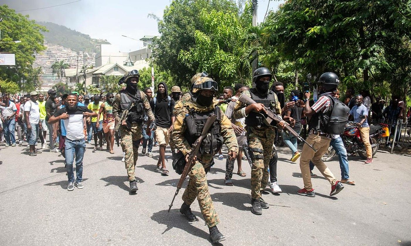 Haitiko Polizia, atxilotuetako bat herritarrengandik banandu nahian, atzo, Port-au-Princen. JEAN MARC HERVE ABELARD / EFE. Haitiko Polizia, atxilotuetako bat herritarrengandik banandu nahian, atzo, Port-au-Princen. JEAN MARC HERVE ABELARD / EFE.
