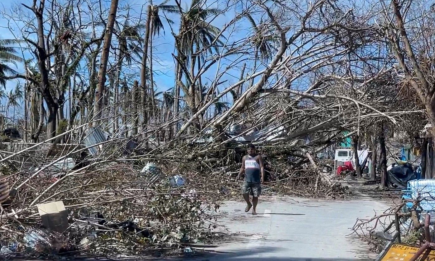 Pertsona bat oinez General Luna herriko kale batean, Siargao uhartean. EFE. Pertsona bat oinez General Luna herriko kale batean, Siargao uhartean. EFE.