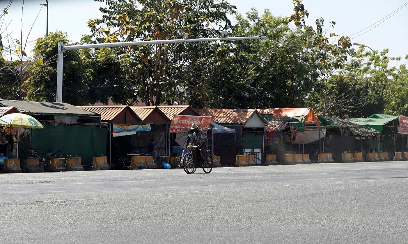 Pertsona bat, atzo, Yangon hiriko kale huts batean. «Greba isila» egin zuten. EFE.