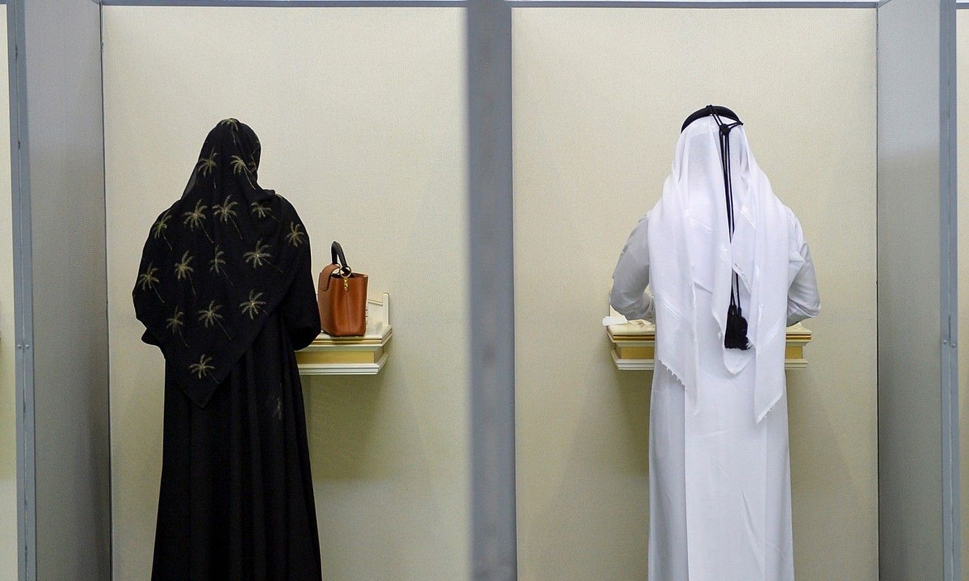 Qatarko emakume bat eta gizon bat bozka ematen, Dohan, 2021eko hauteskundeetan. NOUXAD THEKKAYIL / EFE. Qatarko emakume bat eta gizon bat bozka ematen, Dohan, 2021eko hauteskundeetan. NOUXAD THEKKAYIL / EFE.