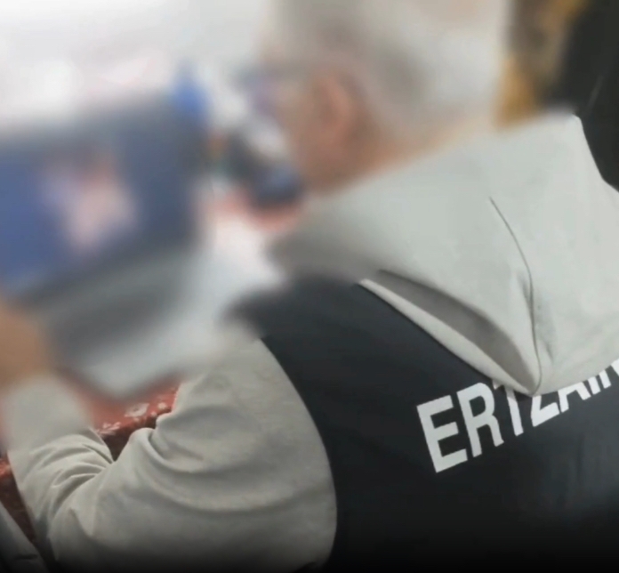 Ertzain bat, atxilotuaren ordenagailua aztertzen. ERTZAINTZA