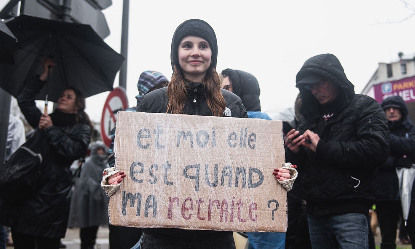 Manifestari gazte bat «Eta nire erretreta, noizko?» dioen afixarekin, atzo, Baionan. GUILLAUME FAUVEAU.