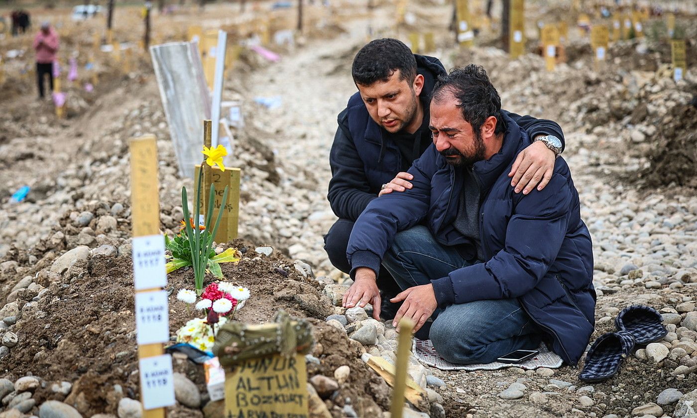 Gizon bat bere emaztearen eta seme-alaben hilobietan, herenegun, Kahramanmarasen (Turkia). S. S. / EFE.