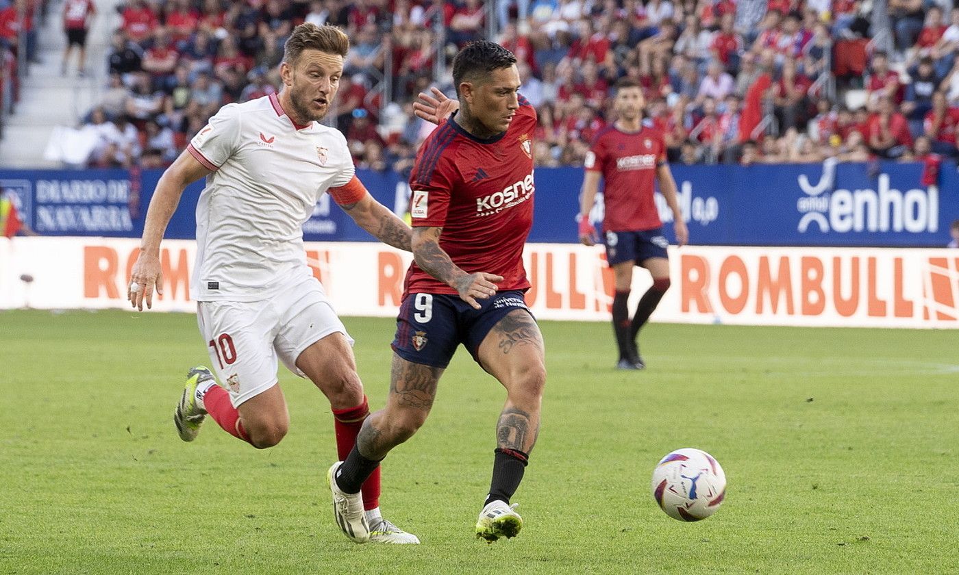 Osasunako jokalari Chimy Avila eta Ivan Rakitic Sevillakoa, baloiaren lehian, atzo, Sadarren, Espainiako Ligako seigarren jardunaldian. IÑIGO URIZ / FOKU. Osasunako jokalari Chimy Avila eta Ivan Rakitic Sevillakoa, baloiaren lehian, atzo, Sadarren, Espainiako Ligako seigarren jardunaldian. IÑIGO URIZ / FOKU.