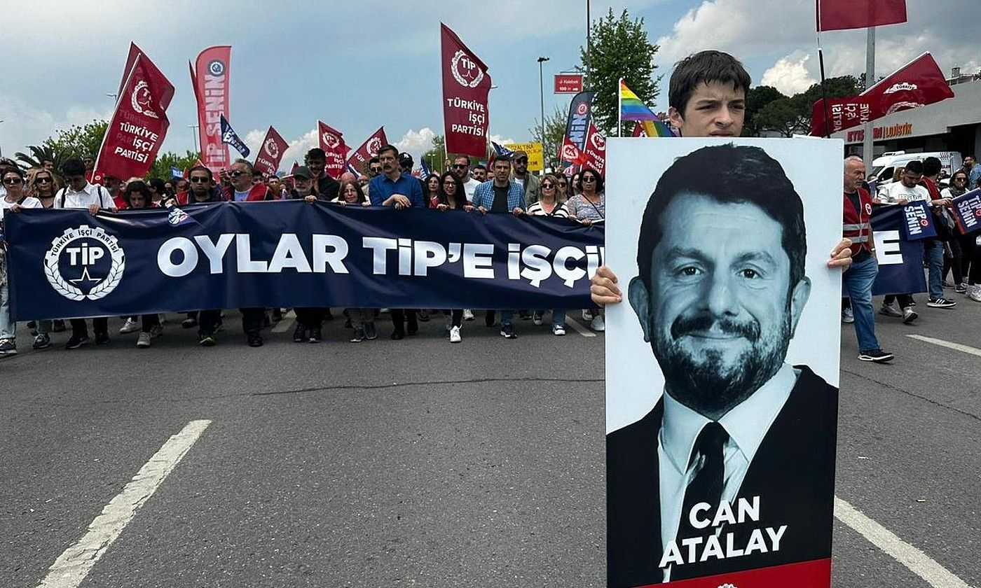 Haur bat Can Atalay diputatuaren irudi batekin, maiatzaren 1eko protesta batean, hura aske uzteko eskatzen. #BARRA_ABILDUA#CANATALAY.