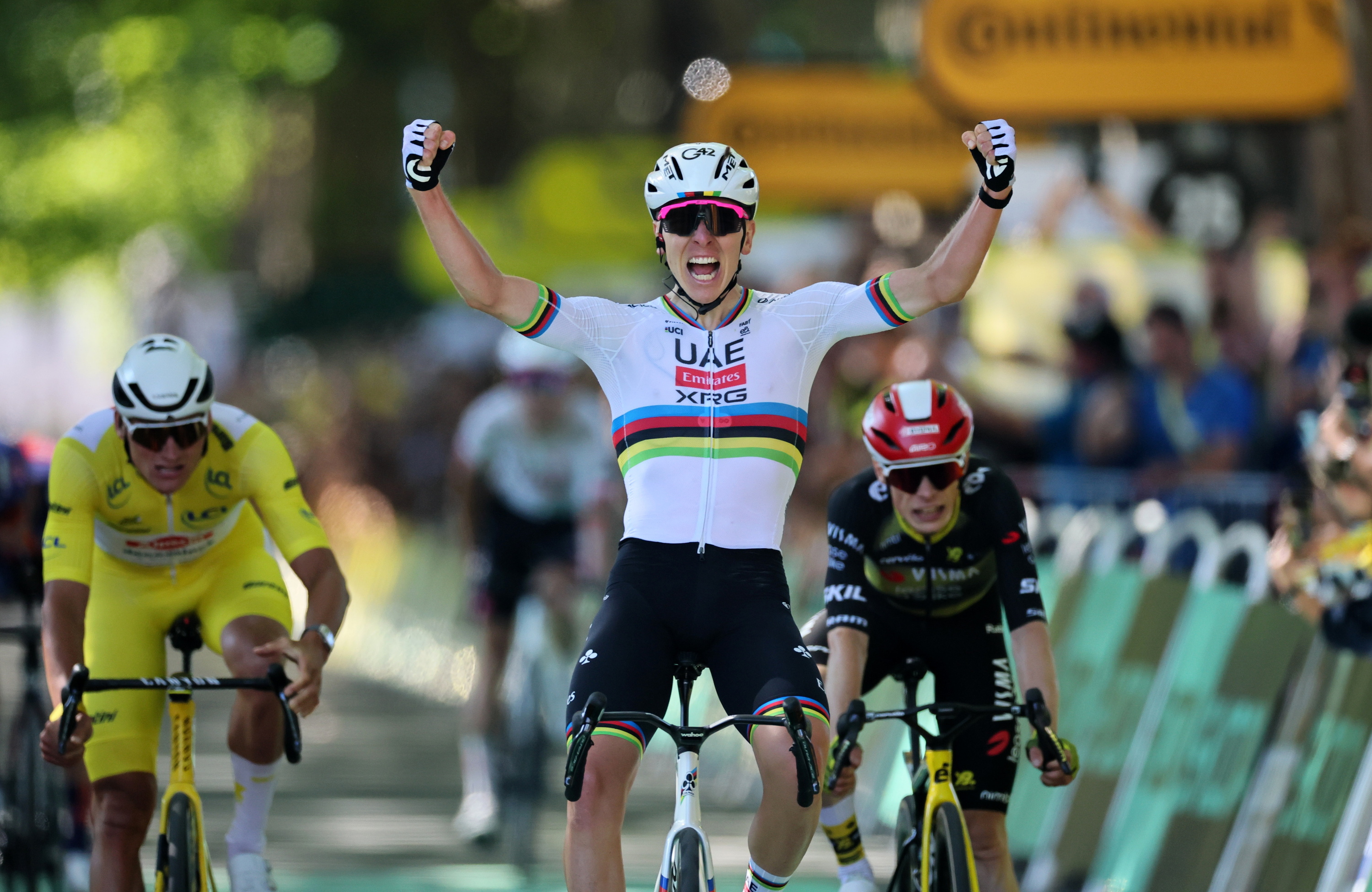 Tadej Pogacar, eskuak altxatuta, etapa garaipena ospatzen, atzean Van der Poel eta Vingegaard dituela. CHRISTOPHE PETIT TESSON / EFE