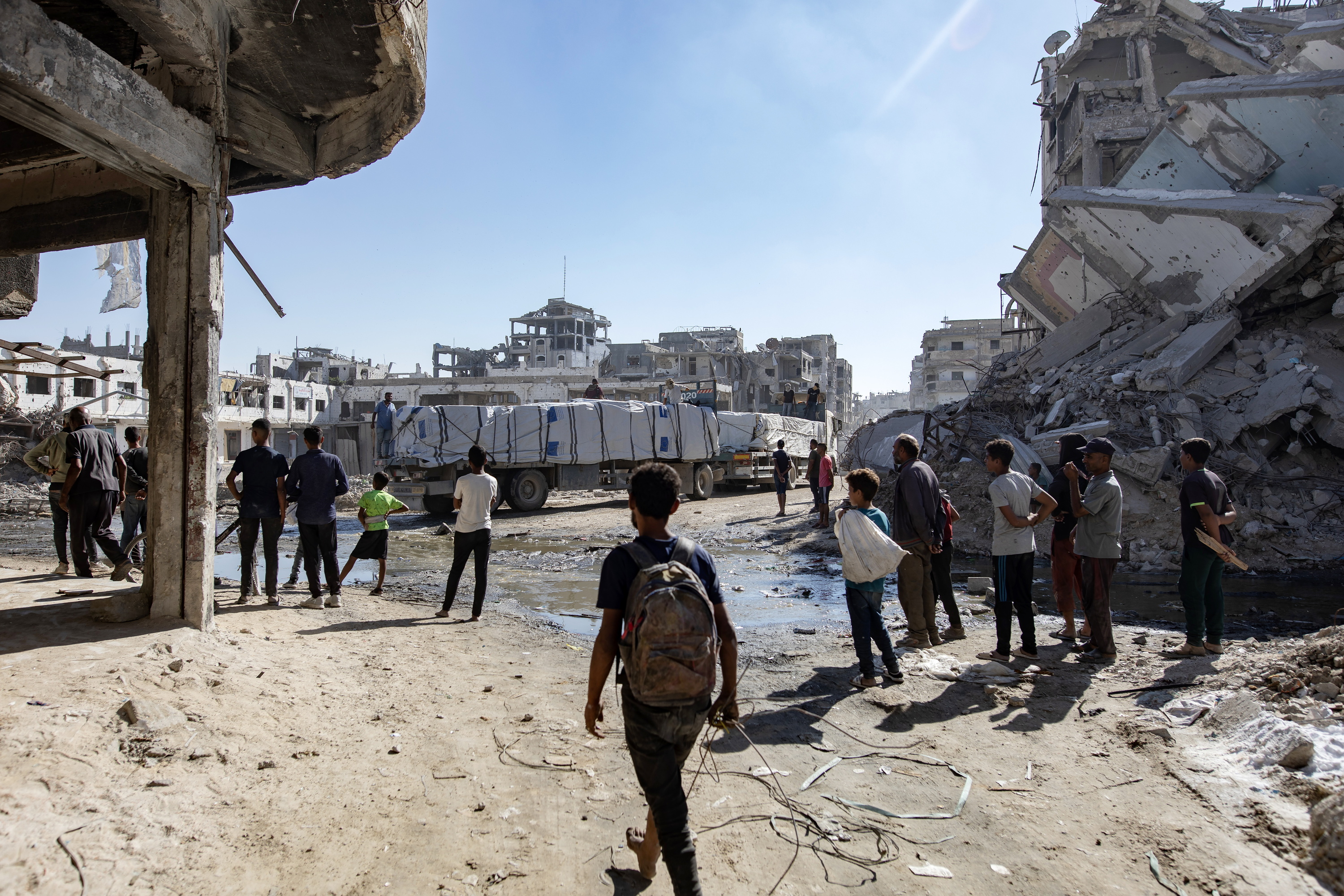 Hainbat palestinar laguntza humanitarioa daramaten kamioien aurrean, atzo, Khan Yunisen. HAITHAM IMAD / EFE