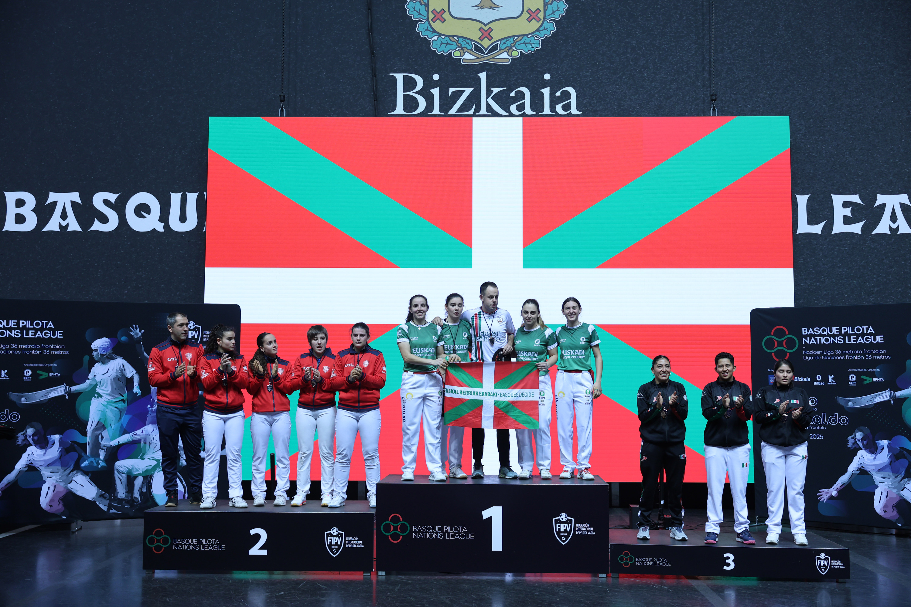 Eskuz binakakoa irabazi duten euskal selekzioko pilotariak, podiumaren lehen koskan. OSKAR MATXIN EDESA / FOKU