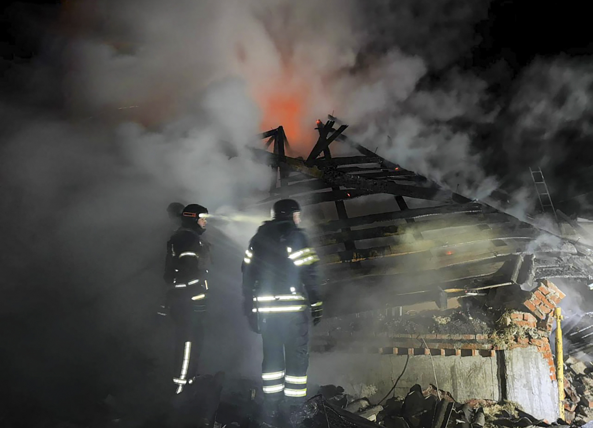 Ukrainako bi suhiltzaile gaur, Kharkiveko etxe baten kanpoaldean. Errusiak eraso egin dio. EFE