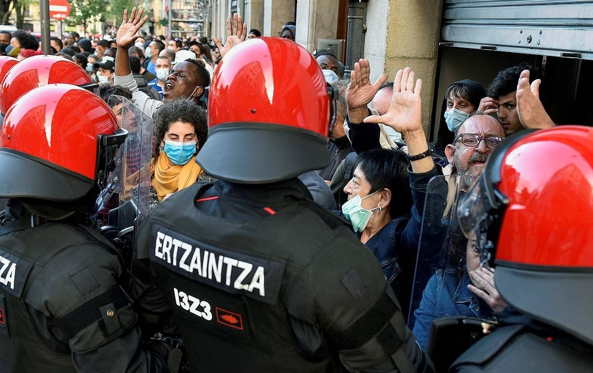 Manifestari antifaxistak, ertzainez inguratuta. MIGUEL TOÑA / EFE