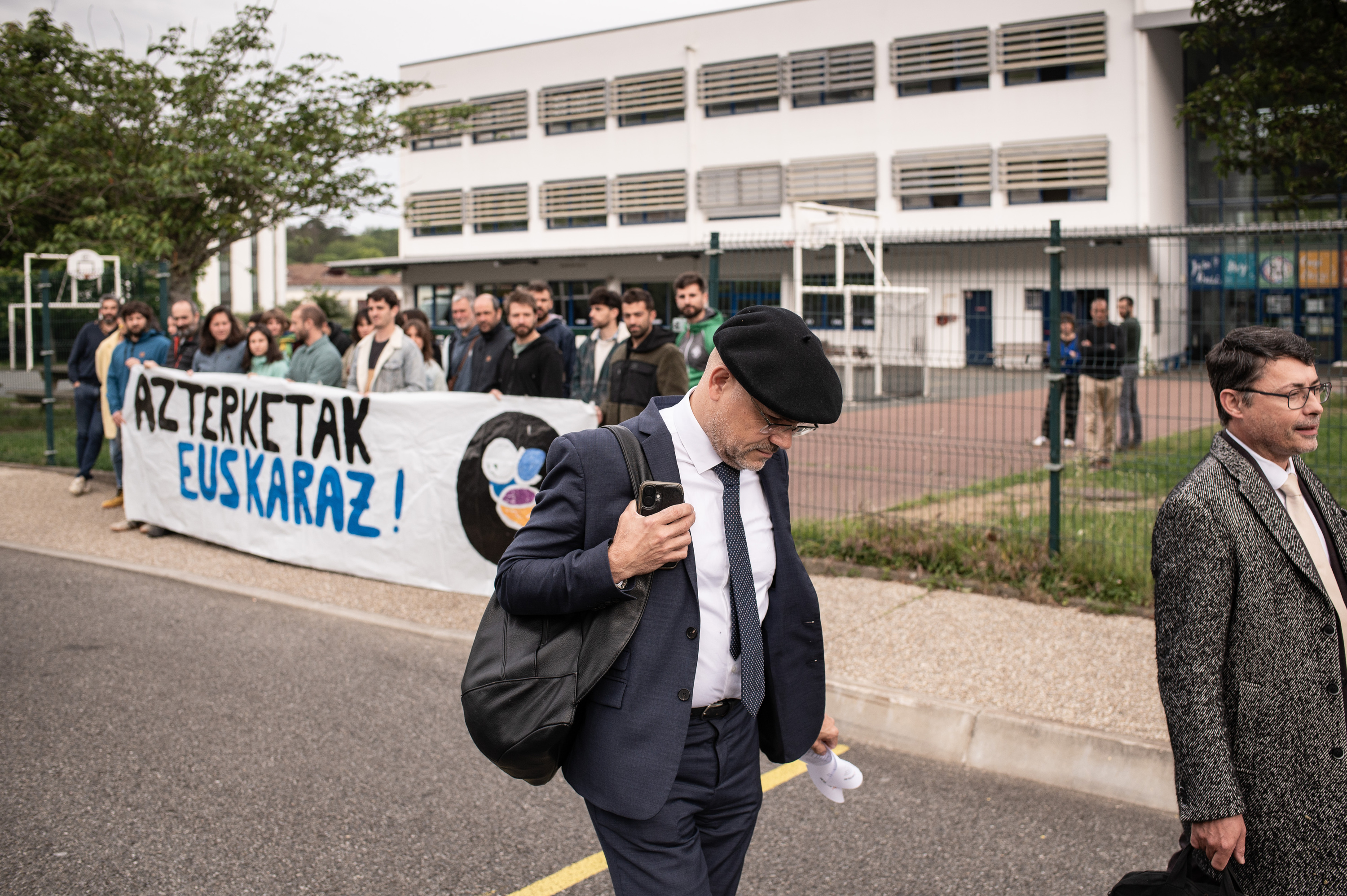 Seaskako irakasle eta burasoek Piarres Larzabal kolegioko sarrera blokeatu dutelako ezin sartuz gertatu diren bi ikuskatzaileak, gibel egiten, gaur, Ziburun. PATXI BELTZAIZ