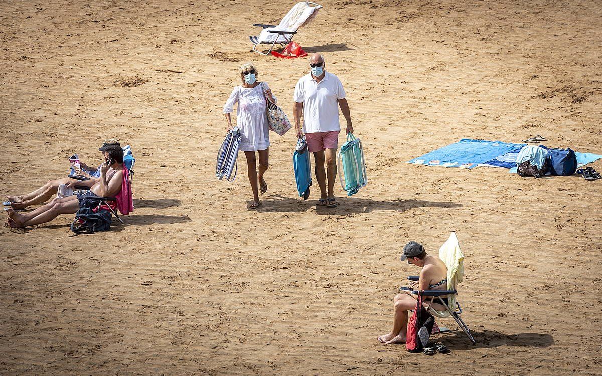 Jendea Zarauzko hondartzan (Gipuzkoa), maskara jantzita. GORKA RUBIO/ FOKU